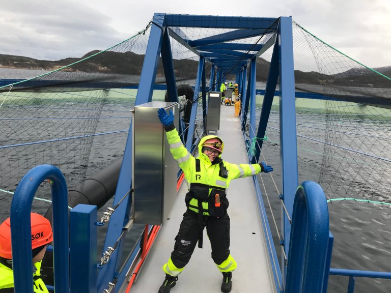 Happy scientist in front of new fish farming cage.