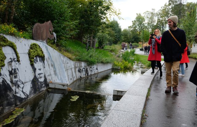 Stream in front of a concrete wall with grafitti