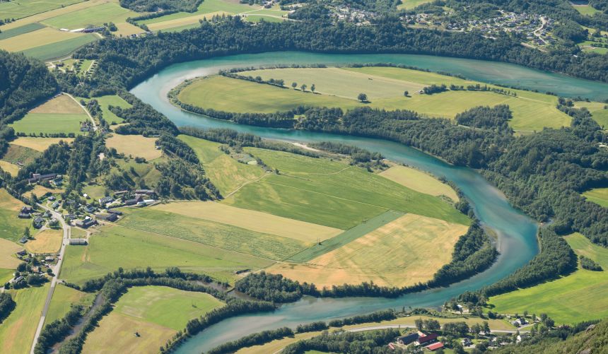 A winding river and agricultural landscape seen from Romsdalseggen, Norway. Stock image from Adobe Stock. Photographer: Ștefan