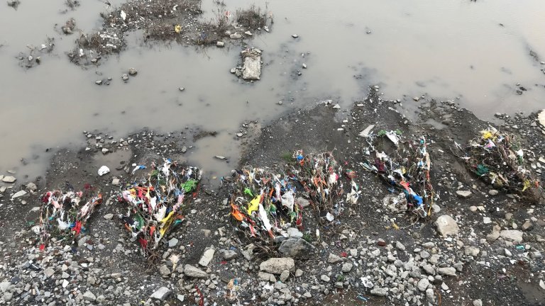 PLASTIC POLLUTION AT RIVER BANK