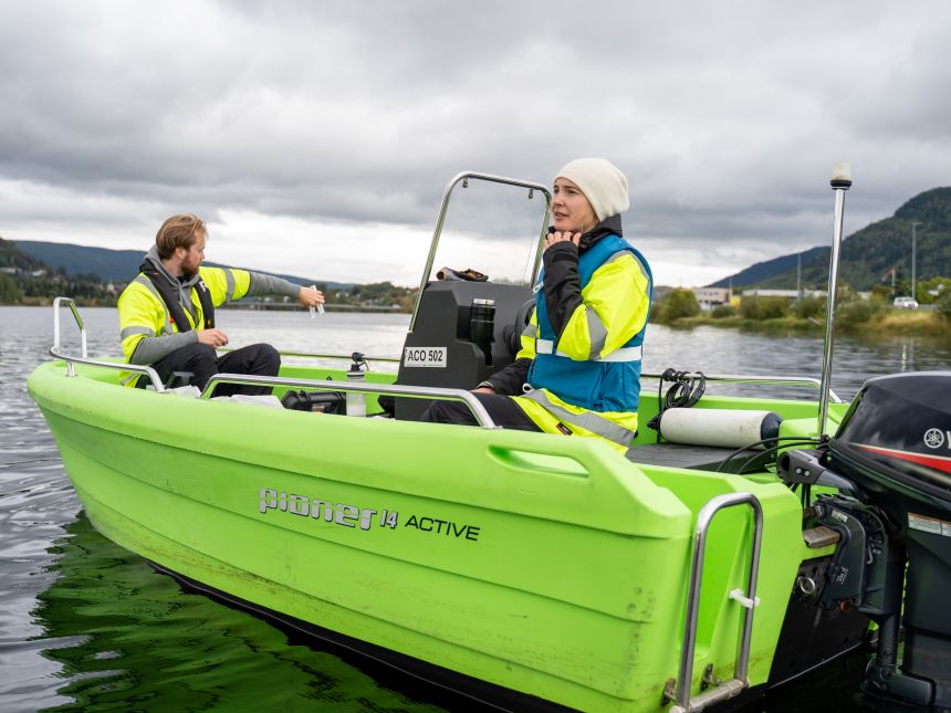 Two people in a green boat 